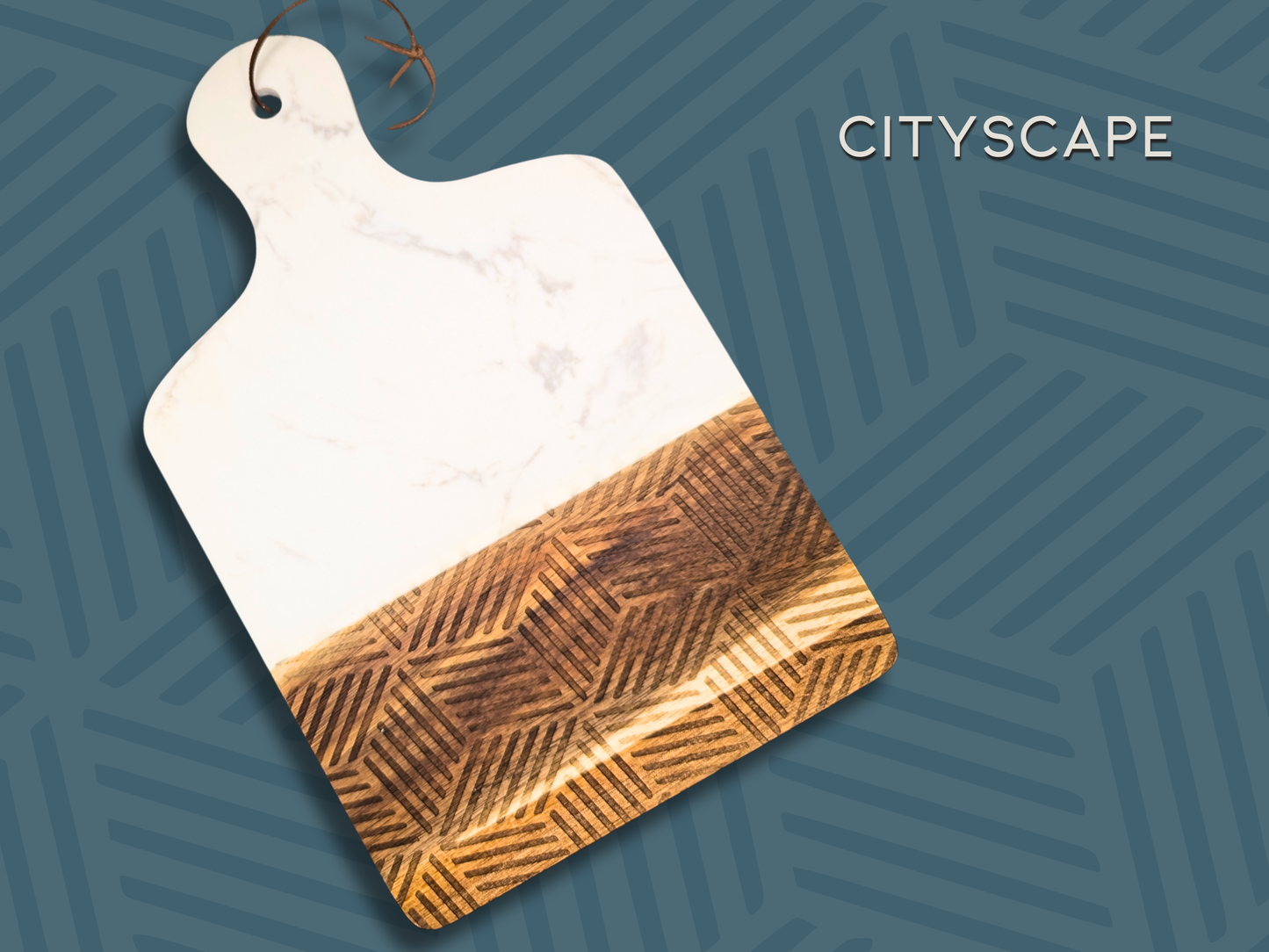 A marble and wooden charcuterie board engraved in the pattern "cityscape". This is a geometric pattern that resembles cubes with three faces visible. Each face is composed of six lines, oriented in different directions